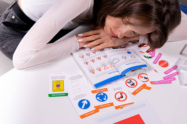 Woman studying driving theory with traffic signs